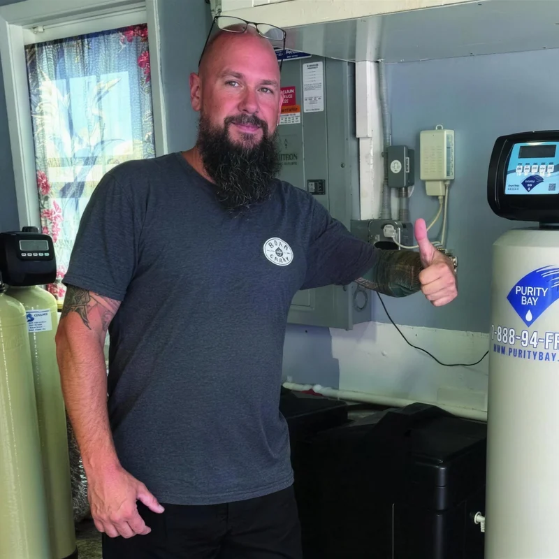 Homeowner giving a thumbs up next to his new Purity Bay system