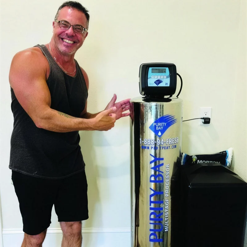 Homeowner pointing at his new Purity Bay stainless multistage tank