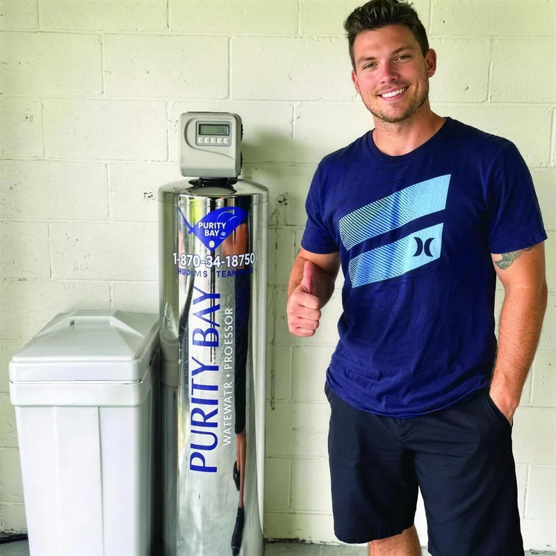 Homeowner beside his new Purity Bay tank and brine tank